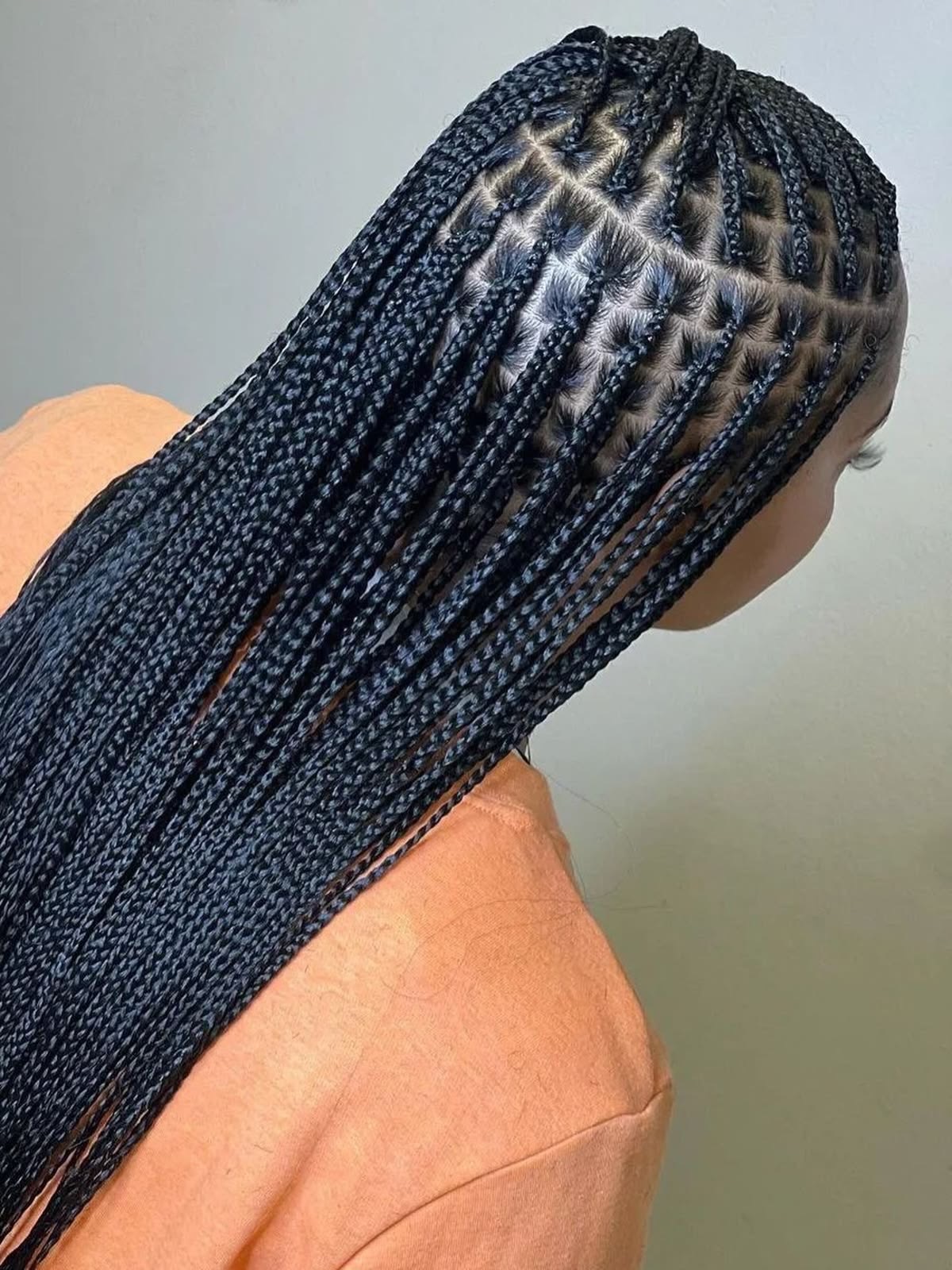 Knotless braids with neat parting, done in Muscat